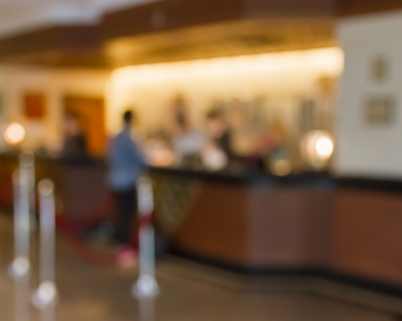 Customers and receptionist at counter in blur motionの写真素材