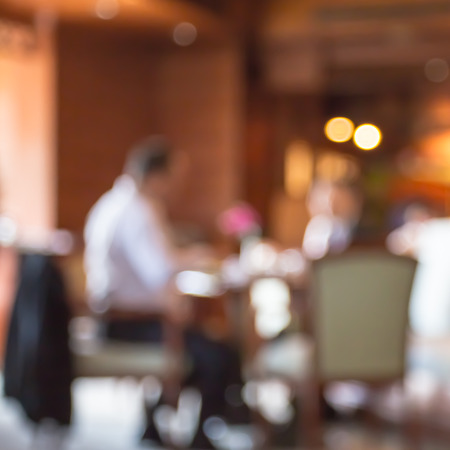 blur people  sitting on seat in dining room with bokehの写真素材