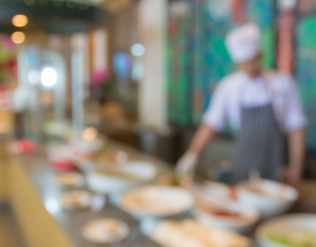waiter or chef in uniform and food table  at restaurantの写真素材