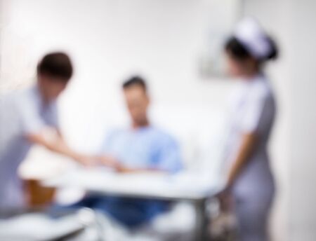 blurred nurse and doctor visit patient on bedの写真素材