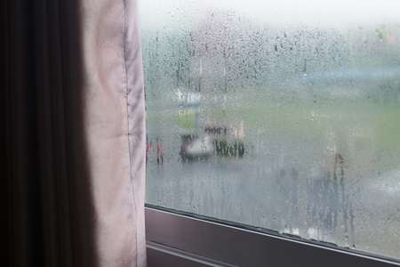 An outside view through the window glass with rain drops.の写真素材