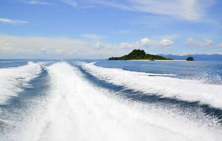 Wake caused by cruise ship or trace tails of speed boat on water surface in the ocean using as natural background.の写真素材