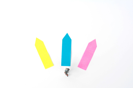 Three direction arrow choices, left, right or move forward, miniature model figure of businessman are taking decisions for the future, choice way.の写真素材