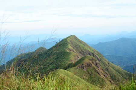 Landscape of Khao Chang Phuak Mountain is located within the Thong Pha Phum National Park, Thailand. Mountain valley and mountain slope with blue sky background.の写真素材