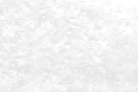 Abstract grey and white circular circle background. Close up of raindrops or water drops on a clear window glass surface. Halftone perspective modern bright art using for a backdrop, wallpaper.の写真素材