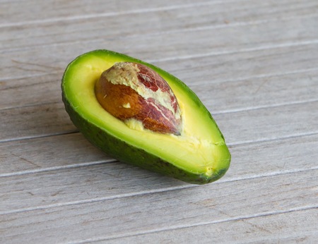 Avocado cut into half revealing its seed