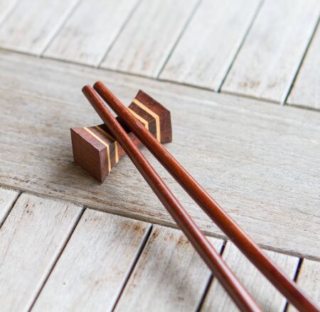 Oriental chopsticks on a wooden tableの写真素材