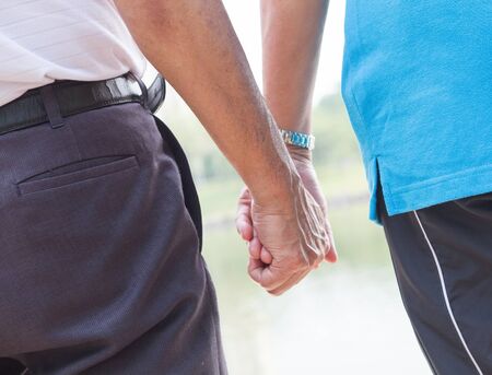 Senior couple holding hands