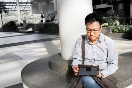 Asian businessman on tablet computerの写真素材