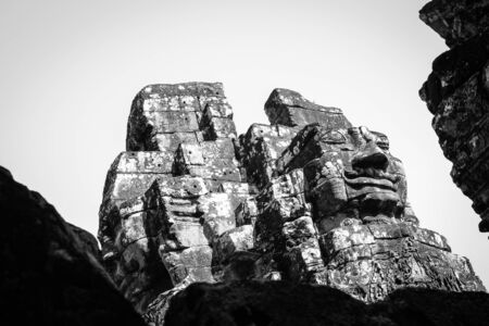 Ancient stone faces of Bayon temple, Cambodiaの写真素材