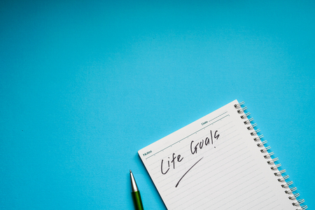 Life goals text on a notebook written by hand with green penの写真素材