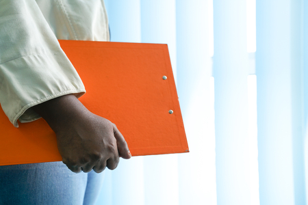 Executive with hand on office clipboard