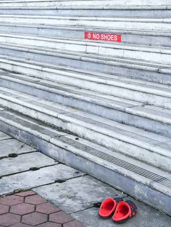 Red color No shoes sign on staircaseの写真素材