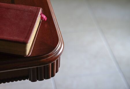 Top view of brown color cover book with pink book mark on the side of wood table. Space for text.の写真素材
