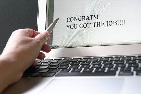 Pen pointed on the typed word, Congrat! You go the job! that appear on the computer screen. Good...