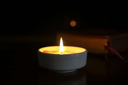 Candlelight with holy bible at the background. Copy space.の写真素材