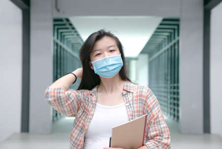 Portrait of an Asian woman wearing medical face maskの写真素材