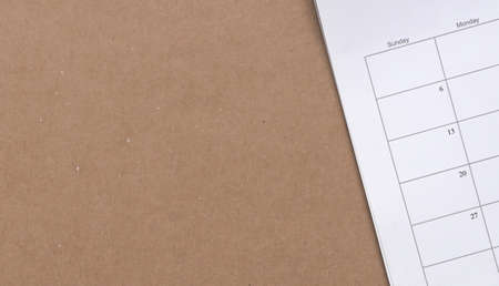 Calendar on brown cardboard paper, copy space. Business meeting, planner and reminder concept.の写真素材