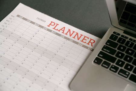 Computer laptop on top of calendar planner