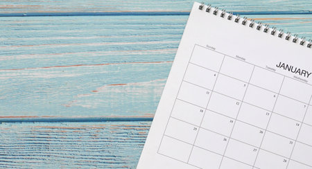 Calendar page on pastel blue color wood table background. Copy space.の写真素材