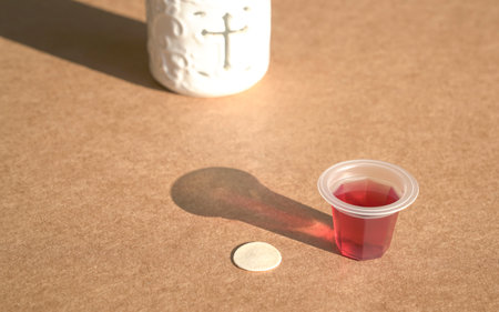 Sacraments of bread and cup of wine for Holy Communion or eucharist. Cross symbol at the background.の写真素材