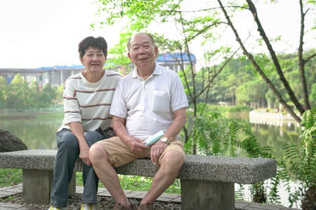 Happy smiling elderly Asian couple at the park. Lifestyle after retirement concept.の写真素材