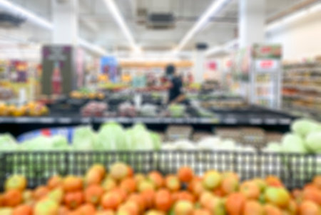 Shopping inside supermarket grocery fresh section, defocused.の写真素材