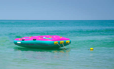Floater in the middle of the emerald blue sea. Hello summer or summertime concept.の写真素材