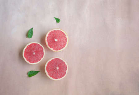 Summer still life with cut grapefruits. Top view, copy space.の写真素材