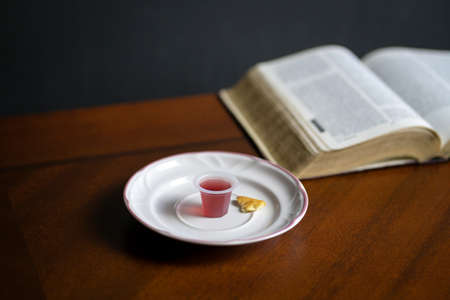 Christian Holy Communion sacraments, wine and bread with Holy Bible at the background.の写真素材