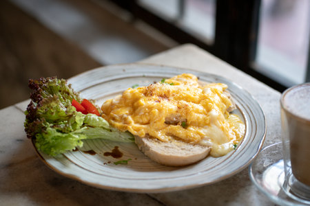Breakfast, scrambled eggs on toast with coffee drink.の写真素材