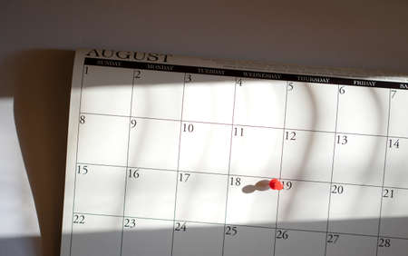 Calendar and marked the date with red pushpin. Top view.の写真素材