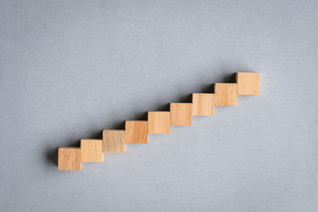 Nine wood cubes arranged as step stair going up. Use as template for text, copy space.