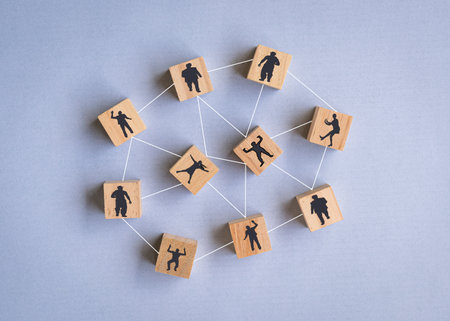 Wooden blocks with people icon on blue background. Team or human resources concept.の写真素材