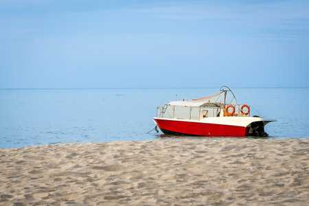 Red and white color speed boat on the beach, copy space.の写真素材