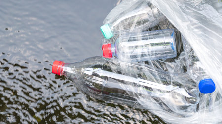 Plastic bottles floating on water surface. Pollution or trash concept.
