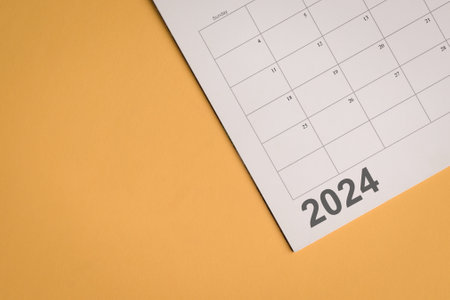 Planner 2024 on yellow background with calendar. Top view.の写真素材
