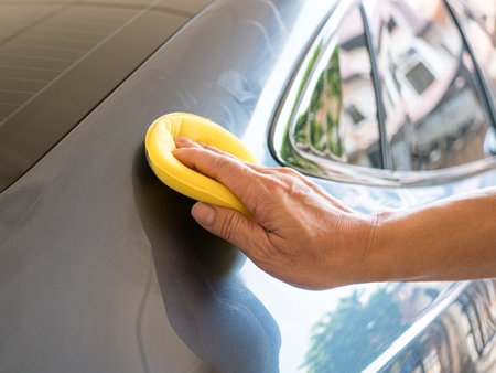 Man waxing a wax or polishing car, close up view. Car care concept.の写真素材
