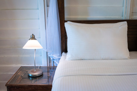 Bed with side table and lamp. Rest and holiday concept.