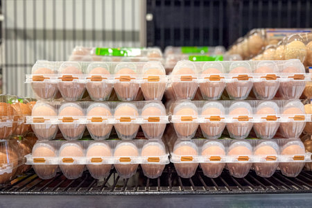 Chicken eggs on supermarket shelves. Essential food or grocery concept.