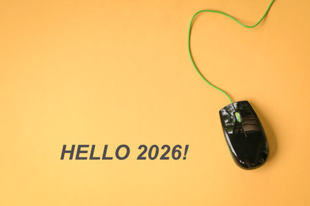 Hello 2026 with computer mouse on yellow surface.の写真素材