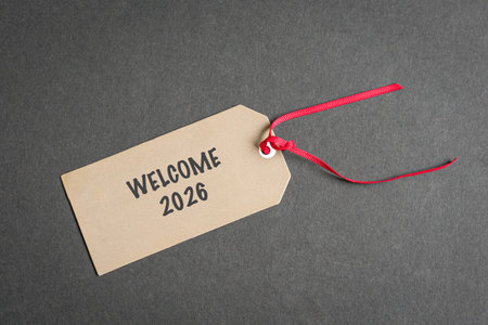 Welcome 2026 on paper tag with red ribbon.