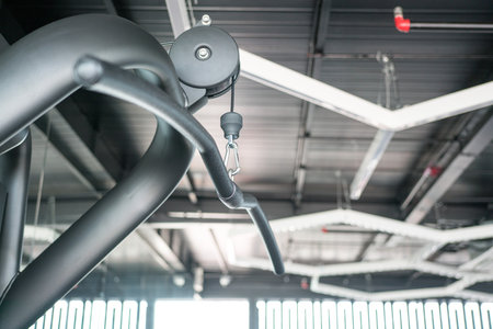Close up view of Lat Pull Down Machine inside a gym. Workout and exercise concetp.
