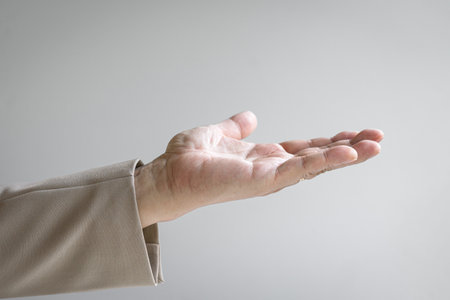 Man stretching out his hand, palm open wide. Take or give concept.の写真素材