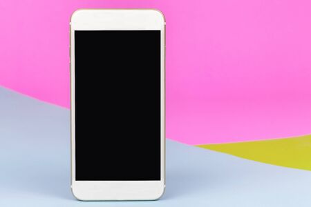 White smartphone on isolated colorful backgroundの写真素材
