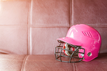 A pink baseball helmet on sofa backgroundの写真素材