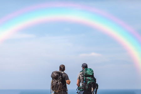Backpacker arriving on destination, looking at the beachの写真素材