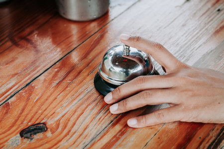 Hand of a woman using a restaurant bell.selective focus.