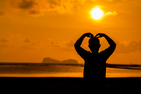silhouette of children with sunrise in the backgroundの写真素材