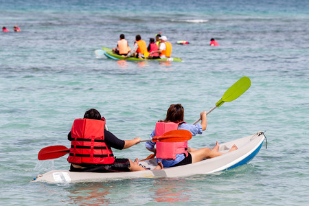 Chonburi, Thailand : 17 June 2018 : Travel concept with family swimming in sea on kyak . Space for textのeditorial素材